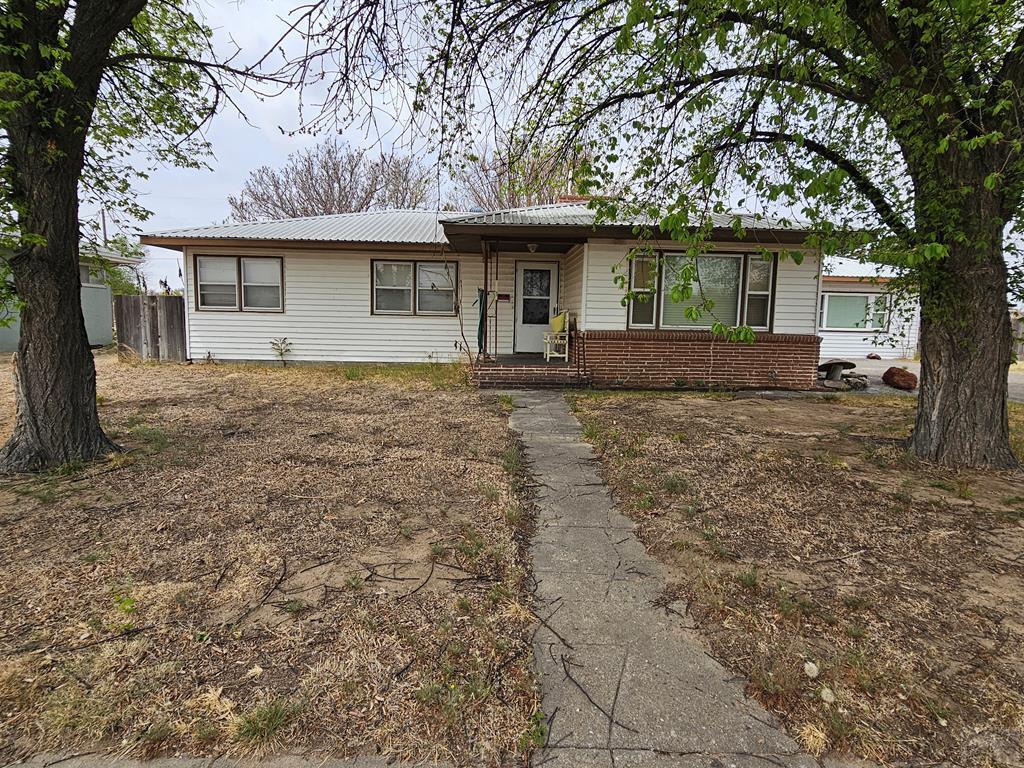 900 Rittgers Street Eads, CO 81036 - Photo 2 of 31 a front view of a house with a garden and trees