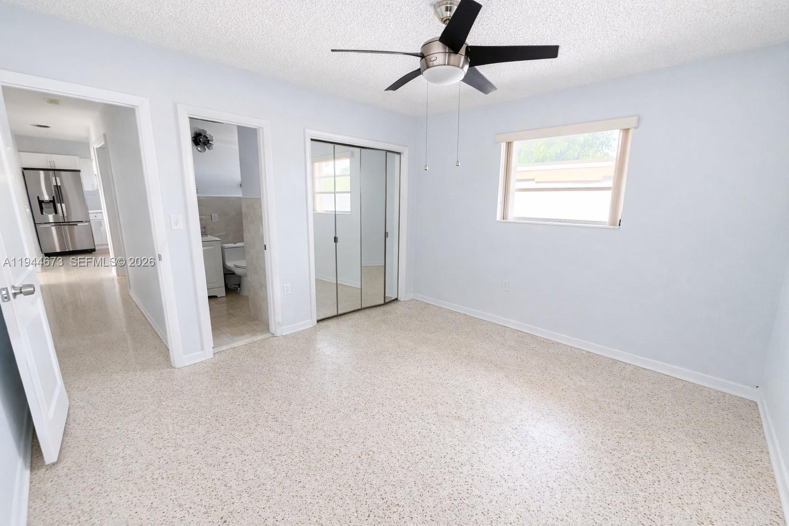 11333 Southwest 7th Terrace Sweetwater, FL 33174 - Photo 8 of 13 wooden floor in an empty room with a window