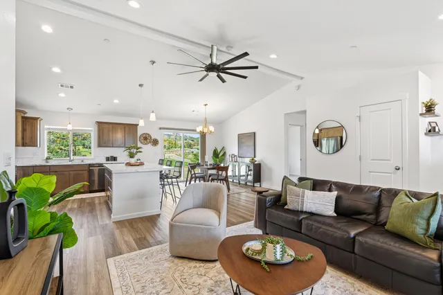 a living room with furniture a rug and a chandelier
