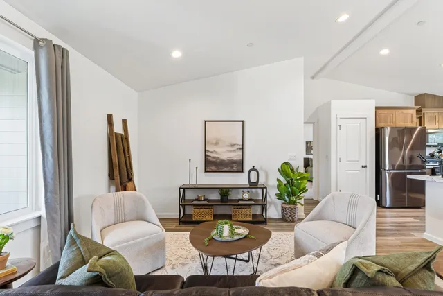 a living room with furniture a large window and a flat screen tv