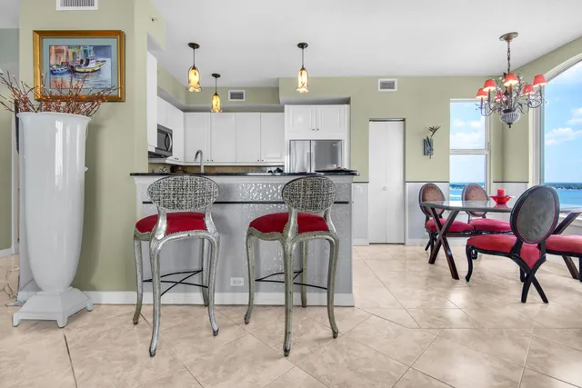 a view of a dining room with furniture and chandelier