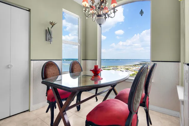 a kitchen with granite countertop white cabinets stainless steel appliances and wooden floor