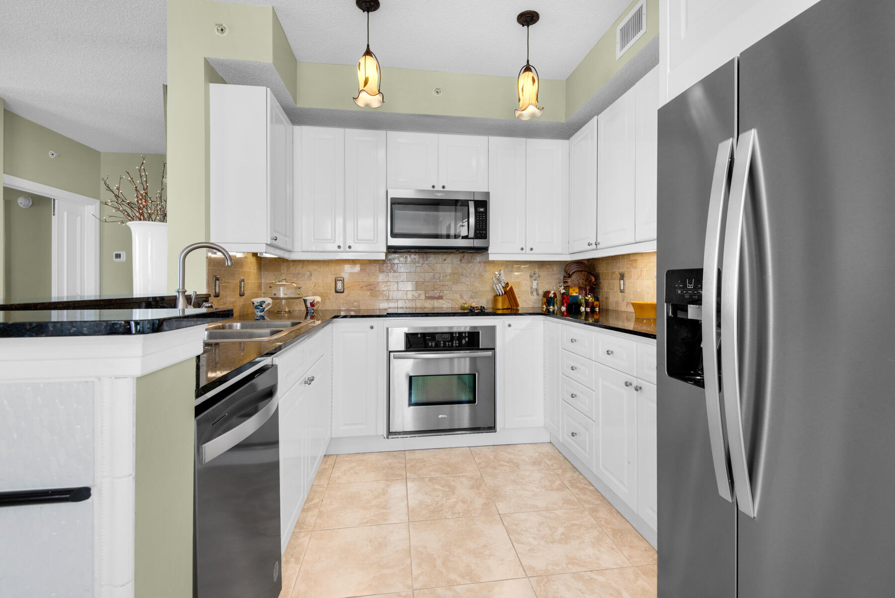 8501 Gulf Boulevard, Unit WPH3A Navarre, FL 32566 - Photo 16 of 66 a kitchen with stainless steel appliances a refrigerator sink and microwave