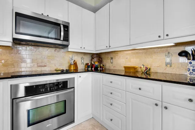 a view of a patio with table and chairs