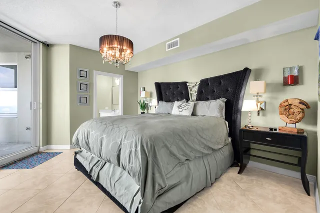 a bedroom with a bed and lamp