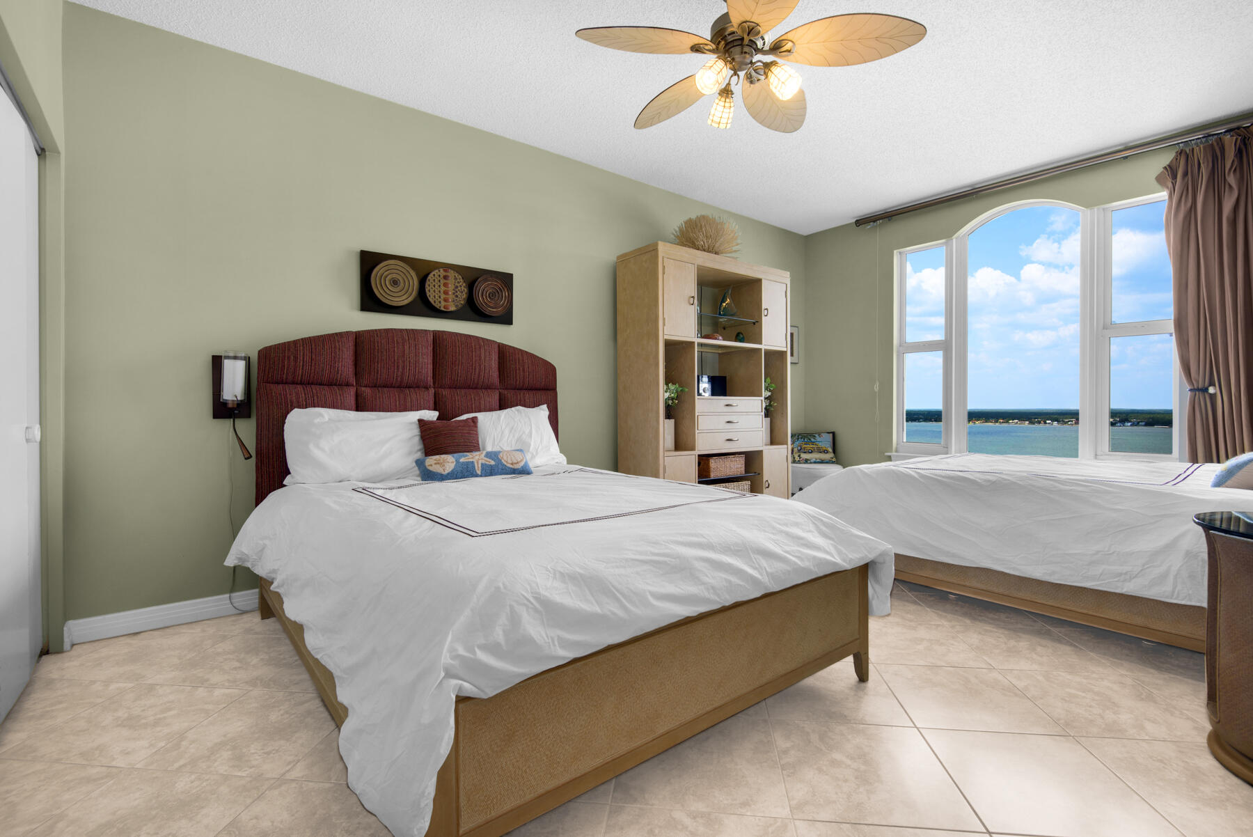 8501 Gulf Boulevard, Unit WPH3A Navarre, FL 32566 - Photo 44 of 66 a bedroom with a large bed and a chandelier