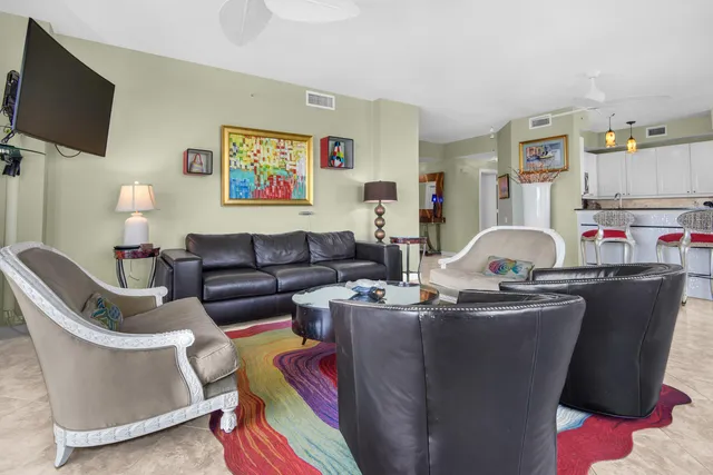 a view of a dining room with furniture and a floor to ceiling window