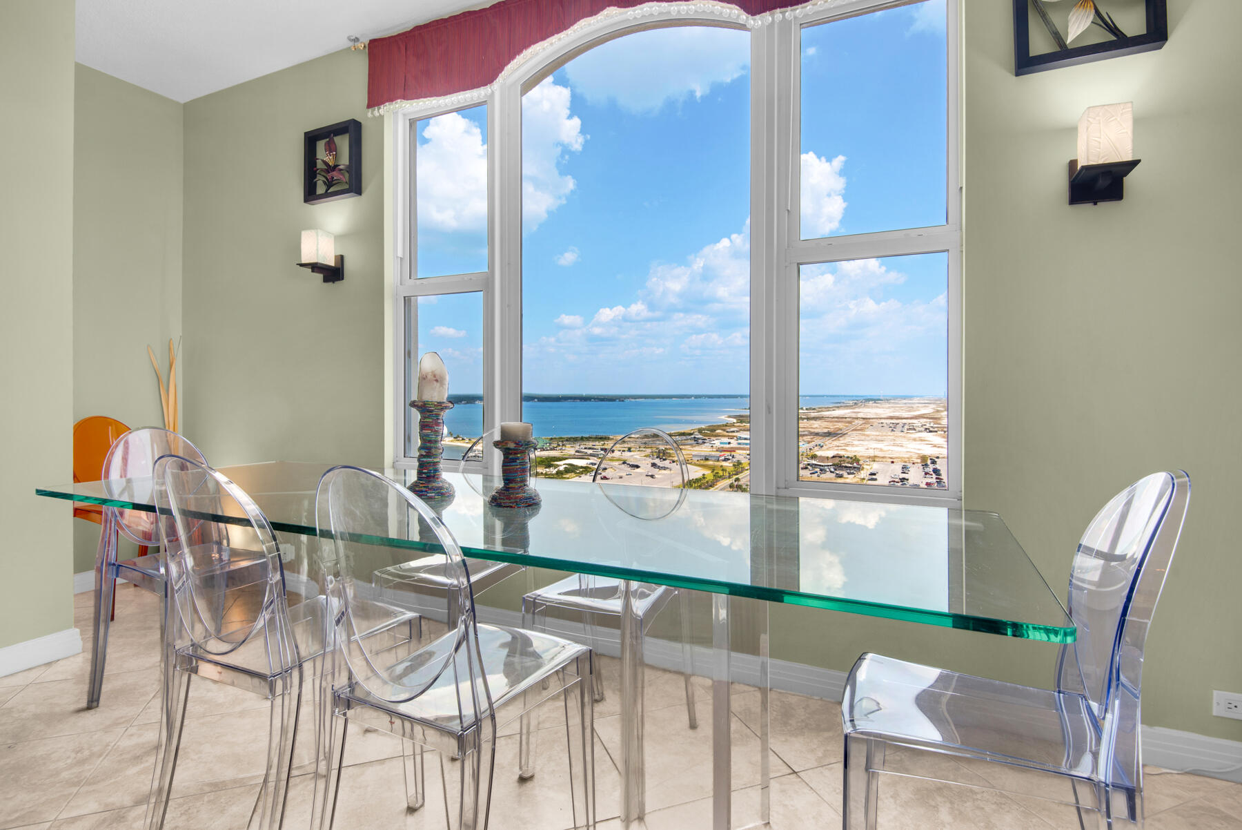 8501 Gulf Boulevard, Unit WPH3A Navarre, FL 32566 - Photo 10 of 66 a view of a dining room with furniture and a floor to ceiling window
