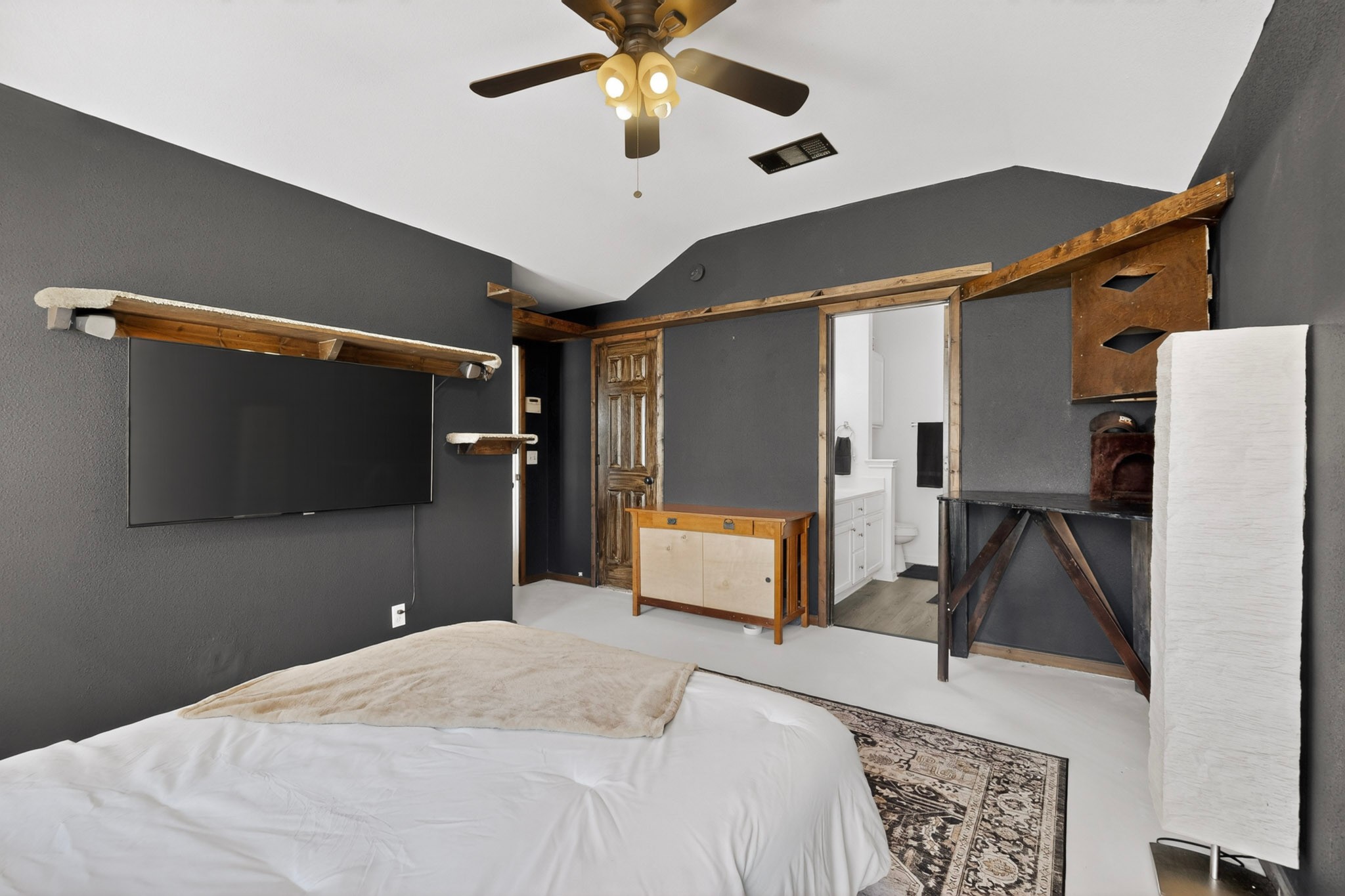 15104 Mimebark Way Austin, TX 78724 - Photo 19 of 38 Vaulted ceiling bedroom featuring dark gray walls and light flooring