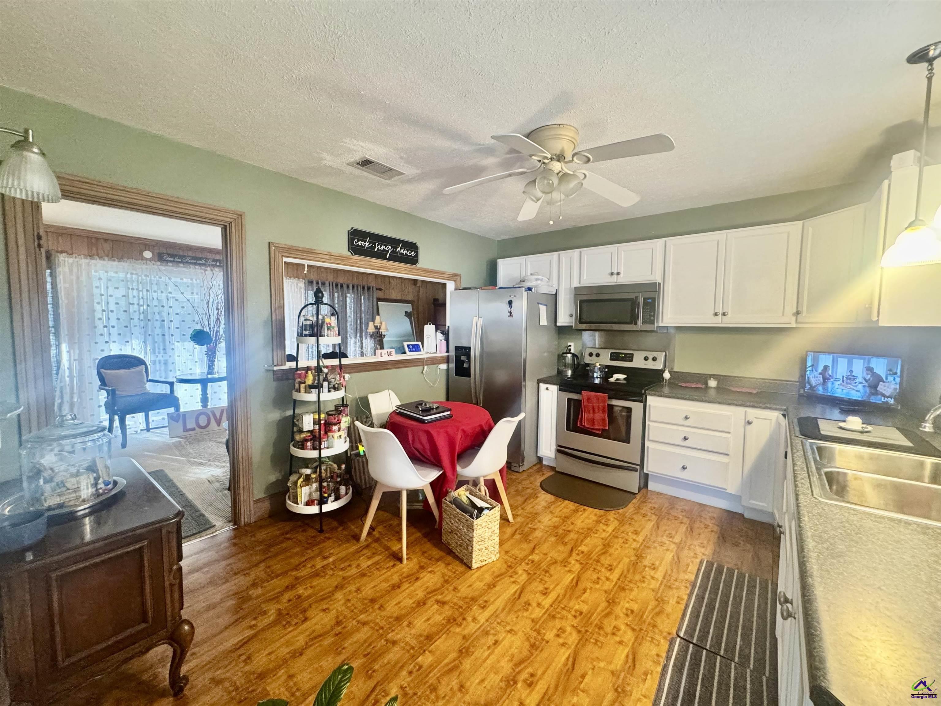 914 Adderton Street Americus, GA 31719 - Photo 19 of 53 a kitchen with granite countertop stainless steel appliances and wooden cabinets