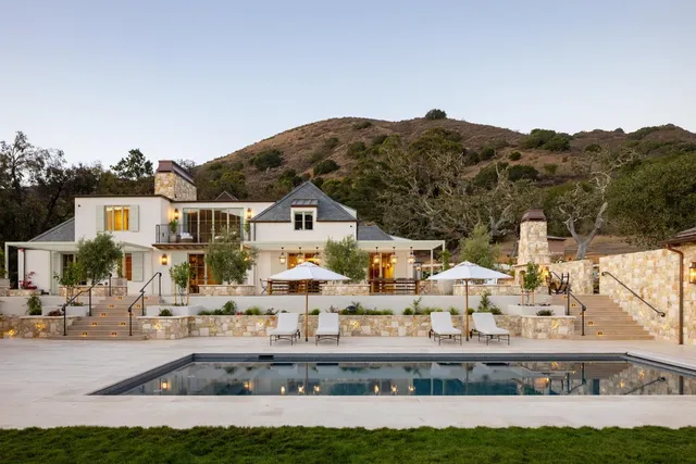 a view of house with outdoor space and swimming pool