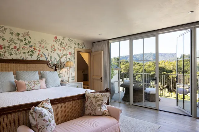 a view of a room with wooden floor lounge chair and windows