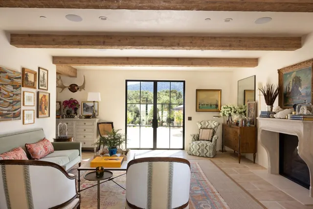 a dining room with a wooden table and chairs