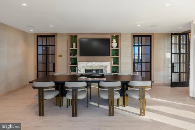 a swimming pool with outdoor seating and city view