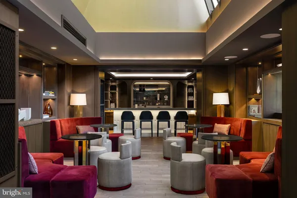 a living room with lots of furniture and kitchen view