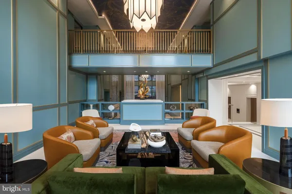 a living room with furniture a chandelier and a floor to ceiling window