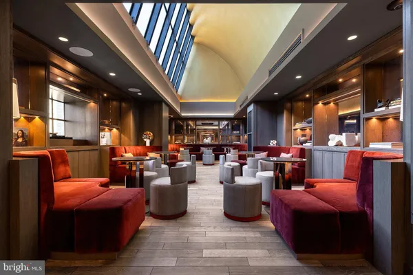 a dining hall with furniture and wooden floor