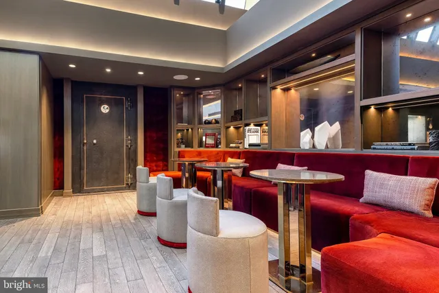 a room with pool table and two chairs