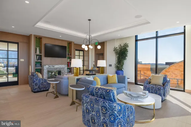 a living room with furniture and large windows