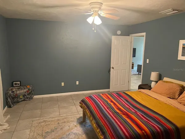 a bedroom with a bed and a chandelier