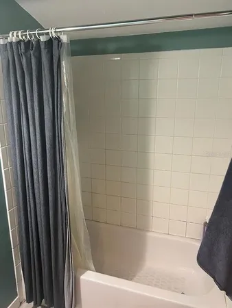 a bathroom with a shower and a tub