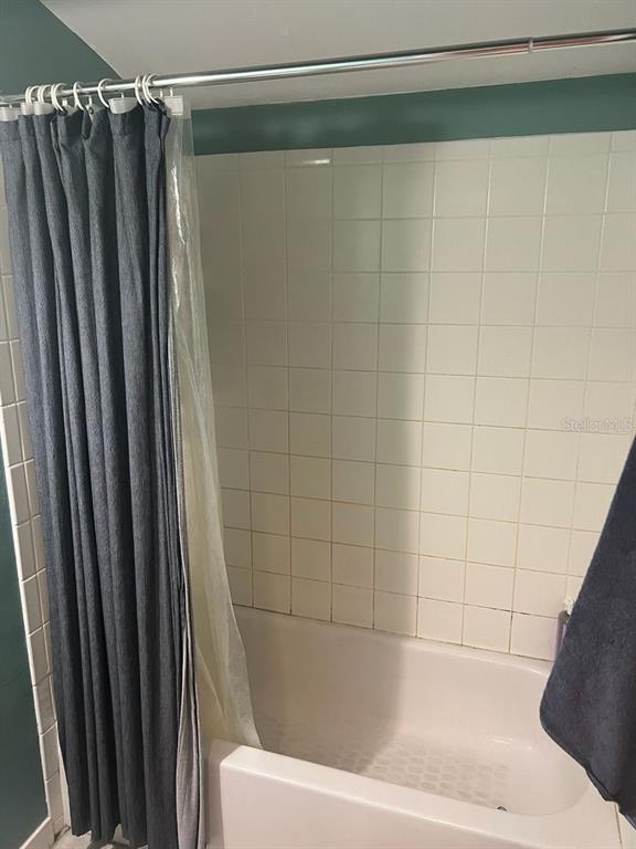 3402 Northwest 2 Street Gainesville, FL 32609 - Photo 13 of 16 a bathroom with a shower and a tub