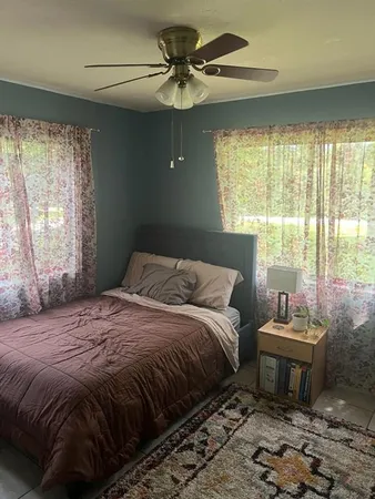 a bedroom with a bed and a window