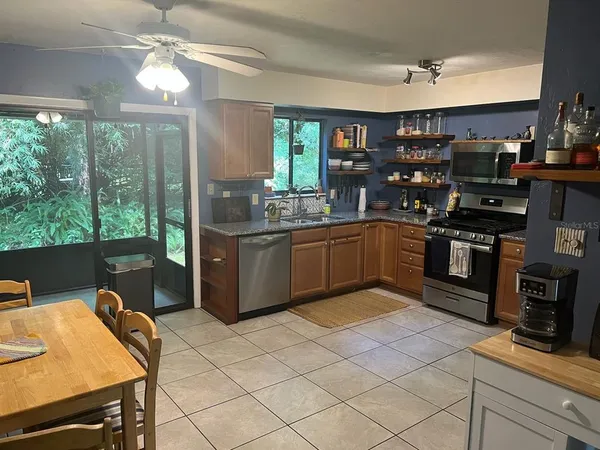 a kitchen with stainless steel appliances granite countertop a sink and a stove