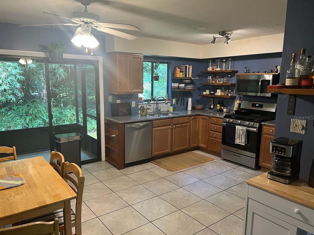 3402 Northwest 2 Street Gainesville, FL 32609 - Photo 2 of 16 a kitchen with stainless steel appliances granite countertop a sink and a stove