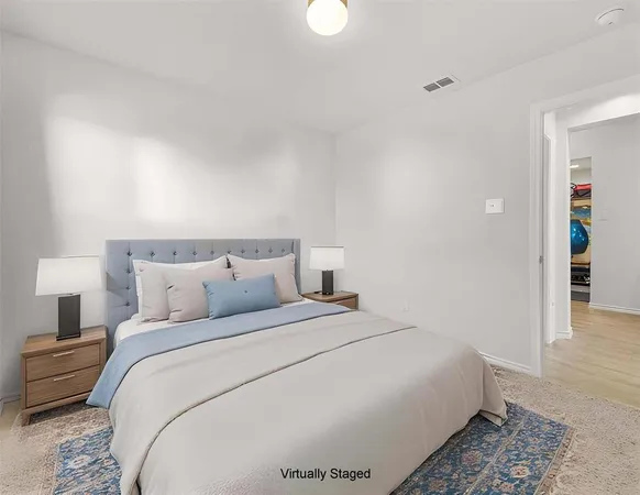 a bedroom with bed and a night stand