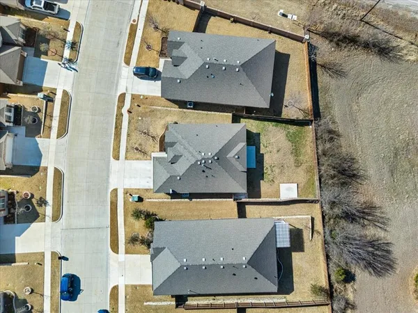 an aerial view of residential houses with outdoor space