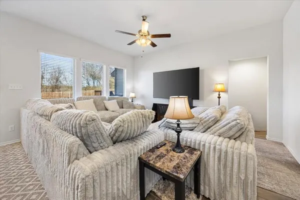 a living room with furniture and a chandelier