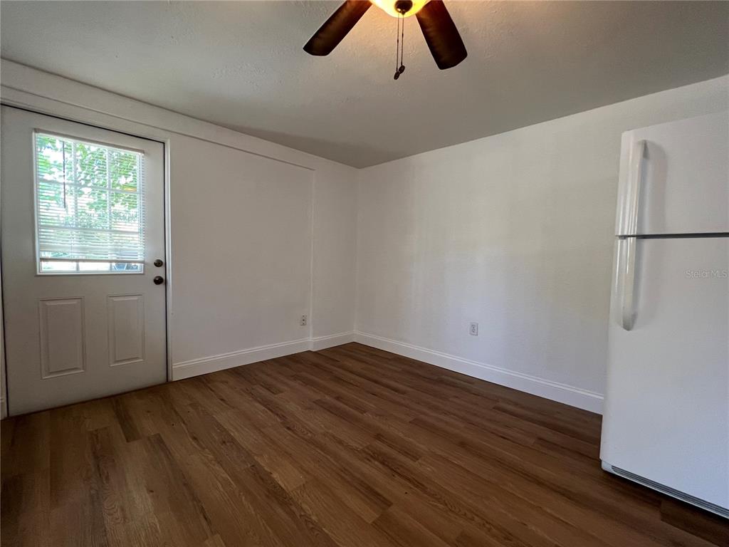 2120 10th Street St. Cloud, FL 34769 - Photo 3 of 8 a view of an empty room with window and wooden floor