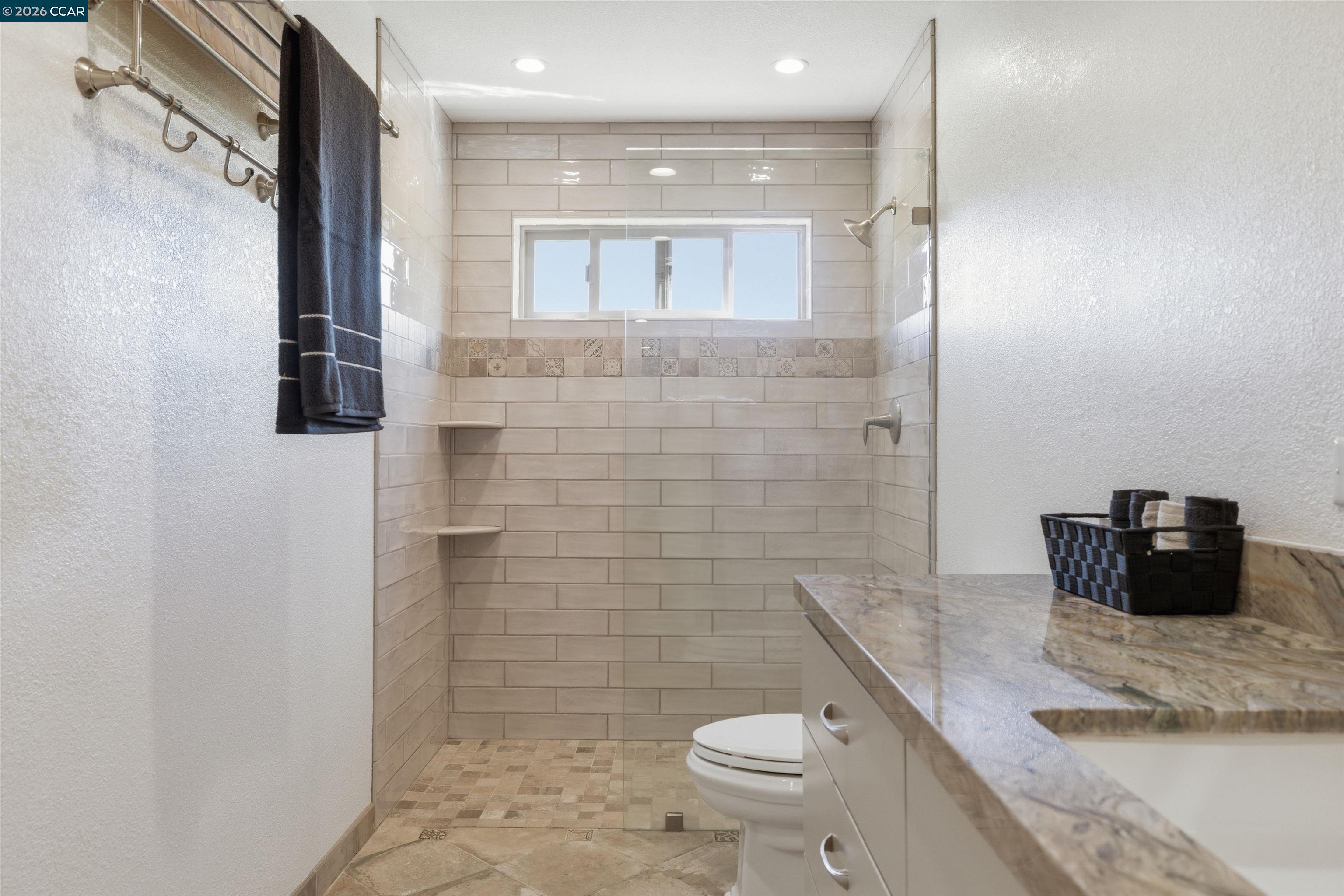 9530 Morgan Territory Road Livermore, CA 94551 - Photo 25 of 55 a bathroom with a granite countertop toilet a sink and shower