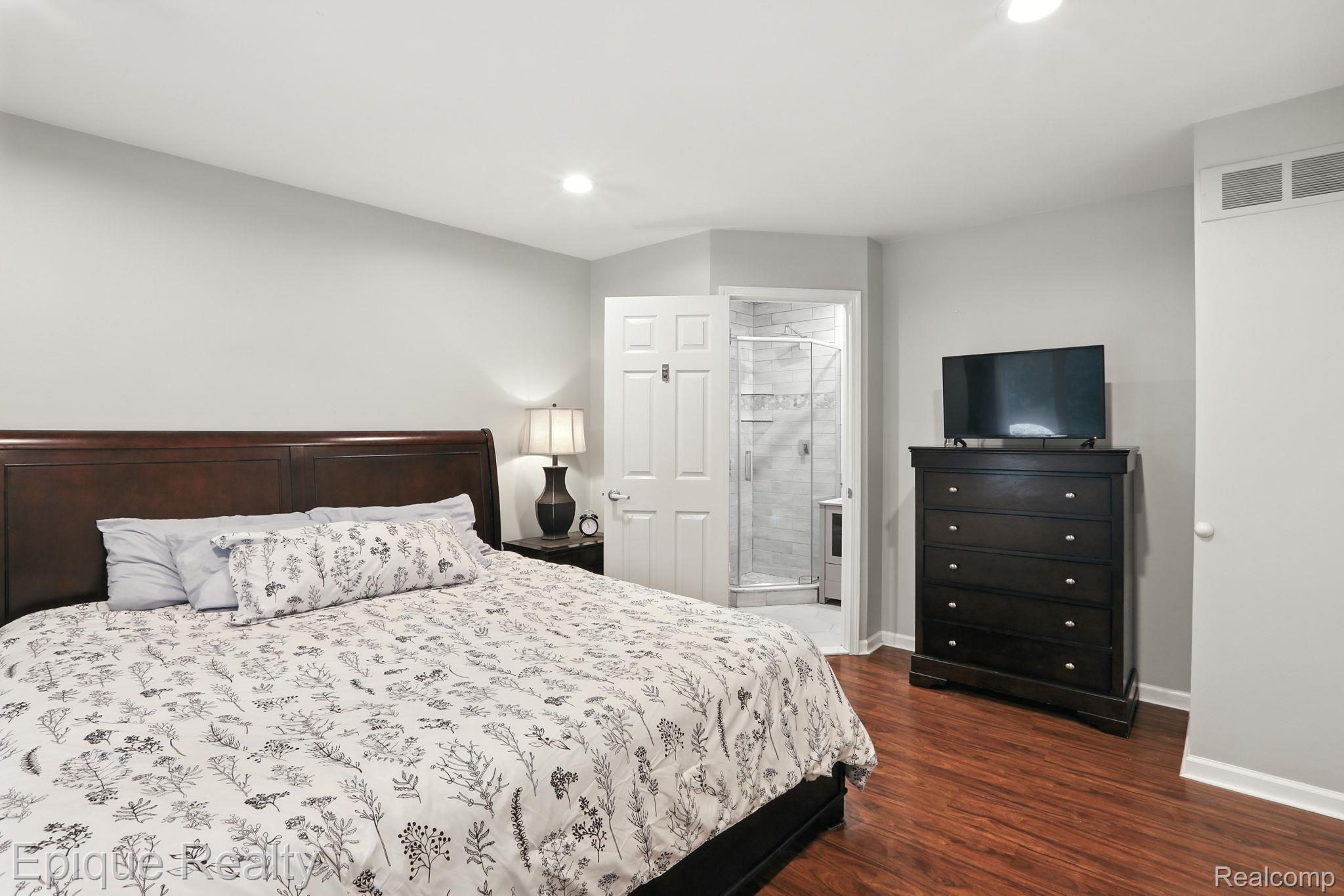 8529 22 Mile Road Utica, MI 48317 - Photo 30 of 40 Bedroom featuring dark wood finished floors, recessed lighting, and ensuite bathroom