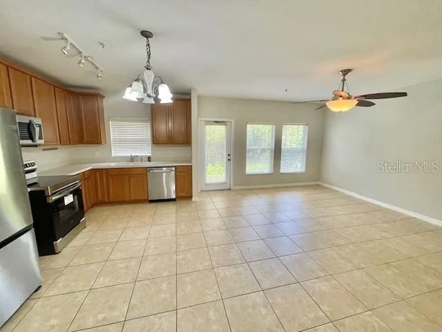 a large kitchen with cabinets and stainless steel appliances