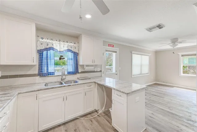 a view of a kitchen cabinets and wooden floor