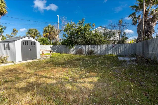 a view of wooden house with a chairs and table in a patio