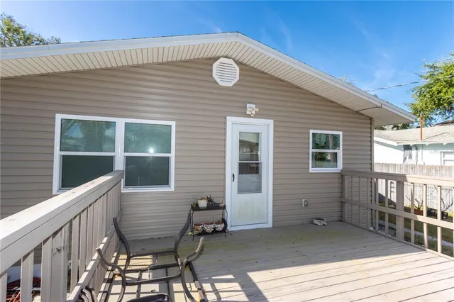 a view of a chair and tables on the wooden deck