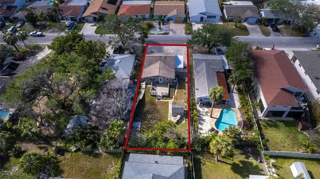 an aerial view of multiple houses with yard