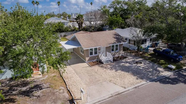 an aerial view of a house with a yard