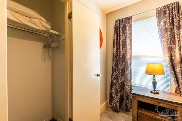 a bathroom with a window and a shower
