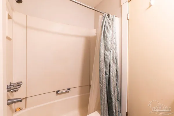 a view of walk in closet with clothes
