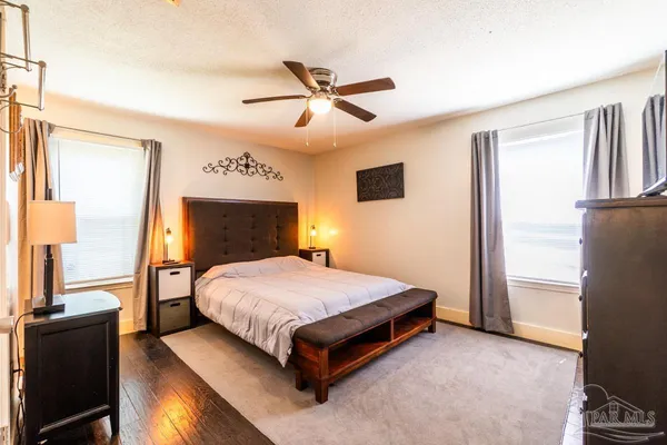 a spacious bedroom with a bed and a chandelier