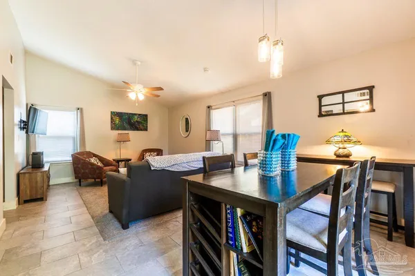 a living room with fireplace furniture and a table