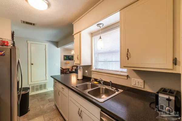 a kitchen with a sink and a refrigerator