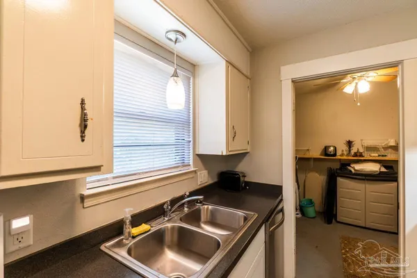 a kitchen with a sink stove and refrigerator