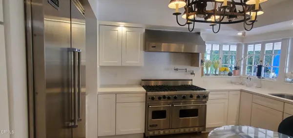 a kitchen with stainless steel appliances granite countertop a stove and a refrigerator