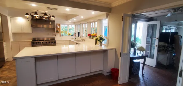a kitchen with a sink and chandelier