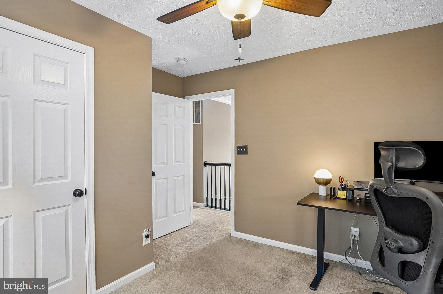 217 Raccoon Run Court Hanover, MD 21076 - Photo 25 of 38 a view of a workspace with furniture and a ceiling fan